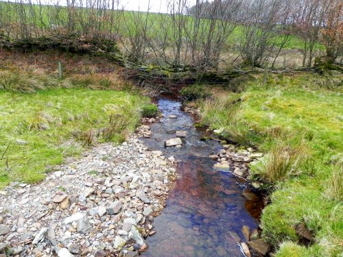 40.-Flowing-past-Twitchen-Ridge-2